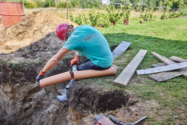 istock When installing septic tank, builder cuts off piece of plastic sewer pipe with an abrasive saw. 2175559312