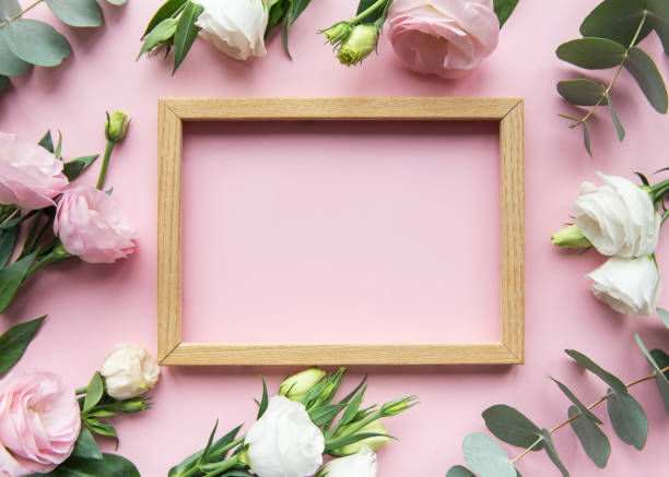 istock Elegant floral frame setup with pink background featuring fresh roses and greenery for decoration or display 2175560050