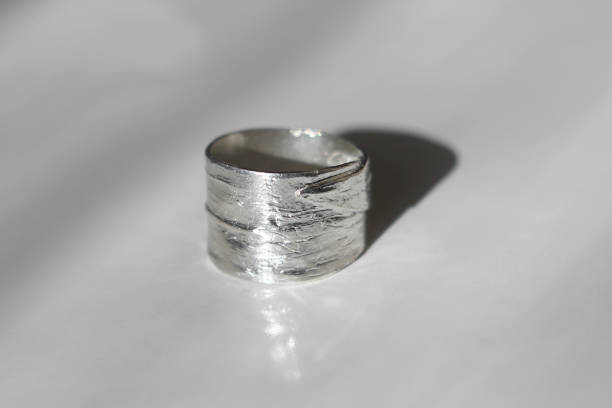istock Minimalist silver ring with a textured surface on a white background. Handcraft precious item. Jewelry accessories. 2175561984