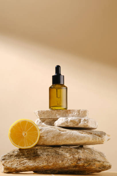 istock Mockup for advertising with a blank label serum bottle displayed on a stack of stone, against on beige background with many sunshine streaming on. Front view, blank space for text 2175564345