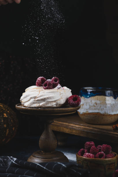 istock Anna Pavlova cake on a stand with raspberries and powdered sugar 2175566512