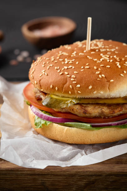 Chicken Burger with Fresh Vegetables on Wooden Tray - Close-Up Shot