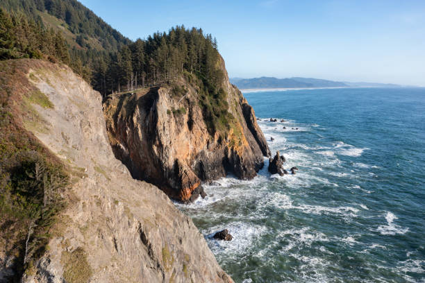 High quality aerial drone photo of Devil's Cauldron at Elk Flats Trail in the beautiful Oregon Coast, near Manzanita, rocky beaches, and great views towards the Pacific Ocean.