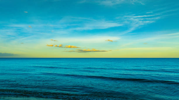 istock Panoramic skyline view The sun sets in the evening sky with colorful clouds. and beautiful cloud patterns In the soft light Evening at the sea 2175570969
