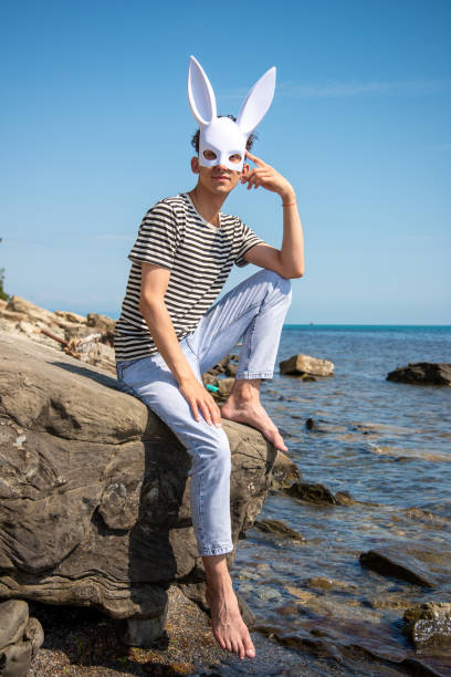 istock A young attractive guy is walking on the beach. 2175571018