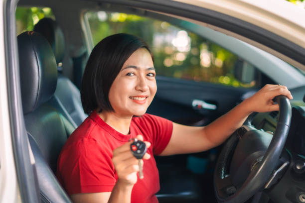 istock Woman happily received used car 2175572201