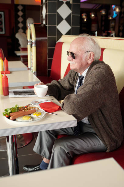 istock Senior Man Enjoying Breakfast in Retro Diner 2175576210