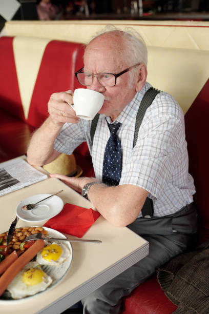 istock Elderly Man Enjoying Coffee and Breakfast at Diner 2175576231