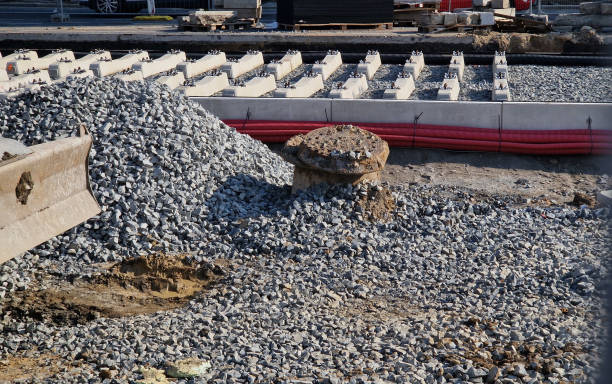 istock new and precise laying of tracks using leveling devices at the fork in two tram tracks. a layer of gravel above which concrete sleepers are placed. rubber anti-vibration base made of rubber 2175577011