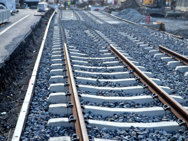 istock new and precise laying of tracks using leveling devices at the fork in two tram tracks. a layer of gravel above which concrete sleepers are placed. rubber anti-vibration base made of rubber 2175577064
