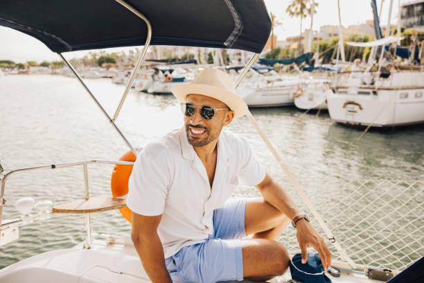 istock Man enjoying a sunny day on a luxury sailboat 2175578418