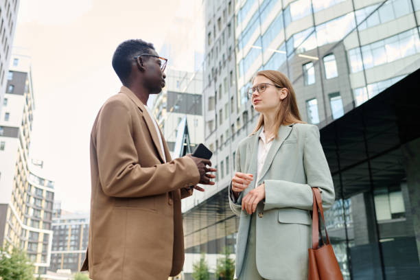 istock Young Colleagues Having Conversation Outdoors 2175578457