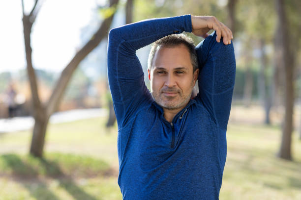 istock Mid-aged man make stretching exercises outdoors on the park 2175578985