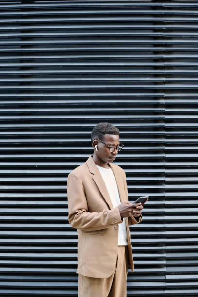 istock Young Black Man Using Smartphone Outdoors 2175579031