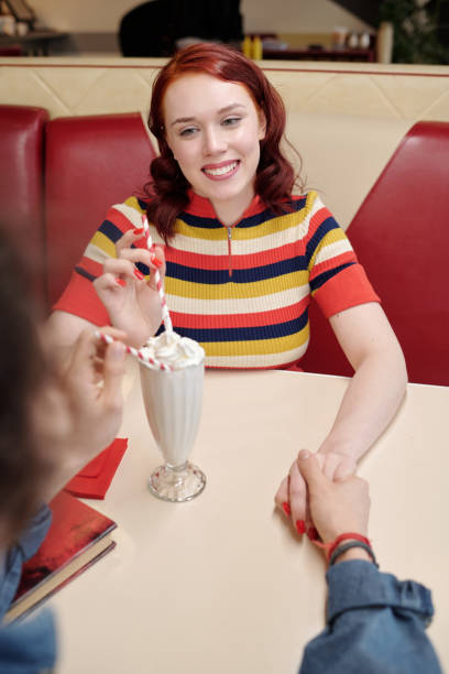 istock Sharing Milkshake at Retro Diner with Smiling Woman 2175579277