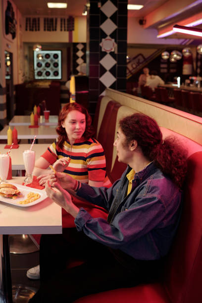 istock Enjoying Delicious Meal in Retro Diner Setting 2175579300