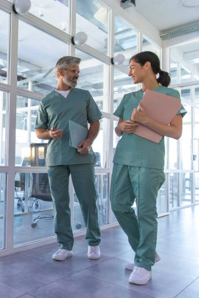 istock Two doctors walking in the clinic corridor and talking 2175579712