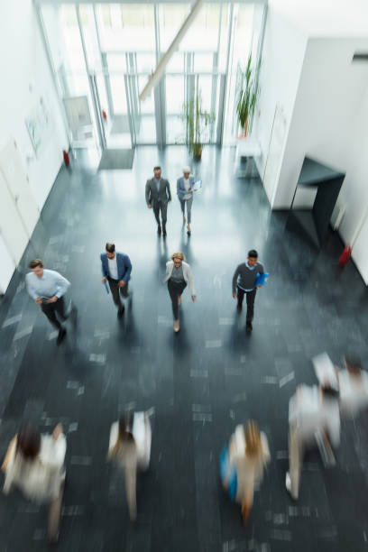 istock Above view of entrepreneurs in blurred motion in a hallway. 2175579993