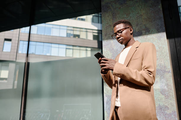 istock Young Black Man Scrolling News Feed On Smartphone 2175580022