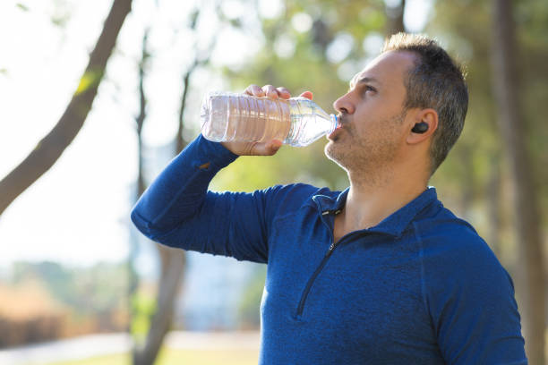 istock Man takes a sip of water after a workout 2175580031