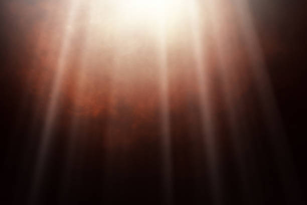 Red Smoke Swirling in Contrast with Black Background and Radiant Light Rays