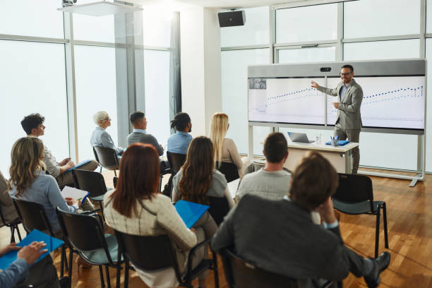 istock Happy male CEO analyzing charts on a seminar in board room. 2175580684