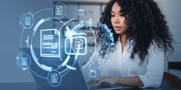 istock Woman working on laptop with digital document icons around her. 2175581265