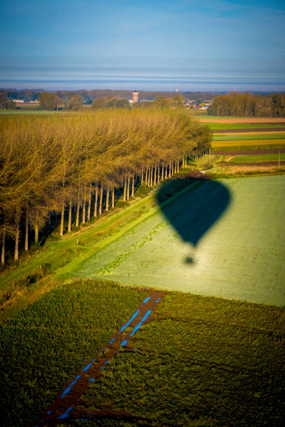 large hot air balloon is in the air flying with people inside its basket enjoying a ride in the air