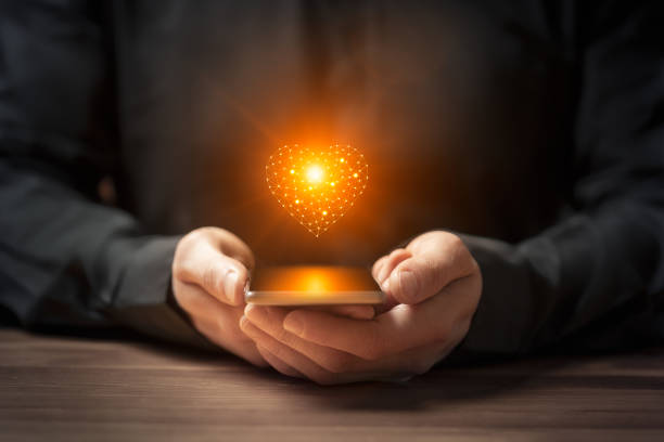 istock Futuristic love concept with hand holding smartphone with glowing AI heart 2175581768