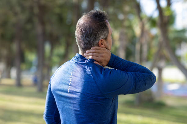 Middle aged man having neck pain
