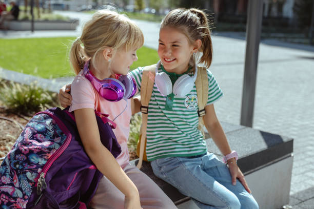 istock Two young cheerful girls chatting outdoors in the park 2175585481