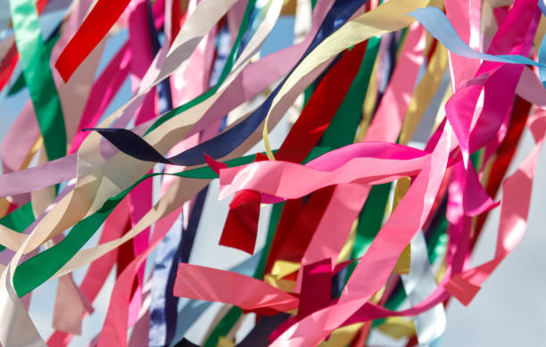 istock Multicolored festival ribbons flutter in the wind. Background 2175585689