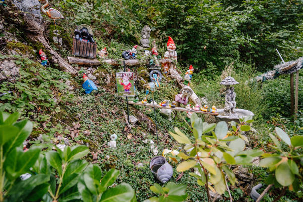 Bavaria, Germany - September 15, 2024 - A whimsical garden display featuring various gnomes, animal figurines, and decorations set on a grassy hillside in Bavaria.