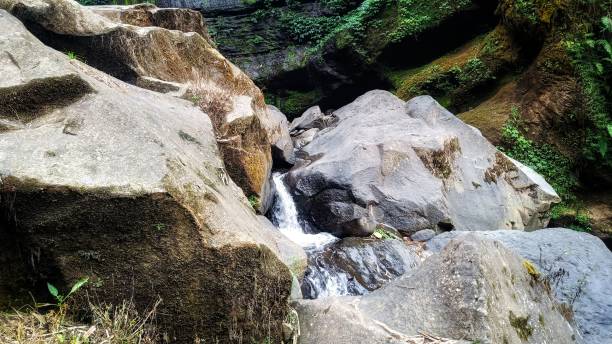 istock Fresh of water from a natural spring flowing between big rocks 2175587688