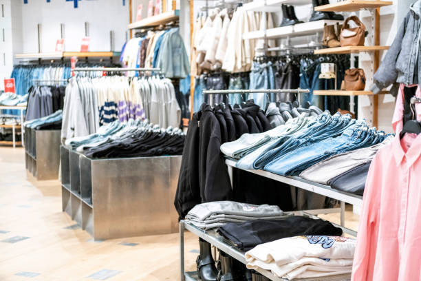 istock Clothes on hangers and shelves in a shopping centre. 2175587763