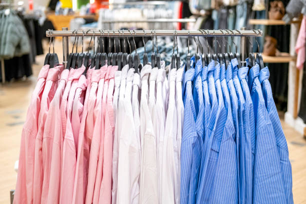 istock Clothes on hangers and shelves in a shopping centre. 2175587800