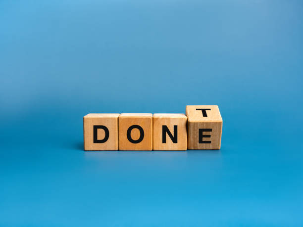 istock Done or Don't, leadership, business marketing concept.Text Done and Dont flipping alphabet letters on wooden cube blocks, isolated on blue background. 2175587933