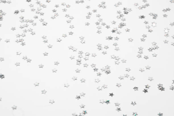 istock sparkles silver stars on white background with text place- Image 2175588575