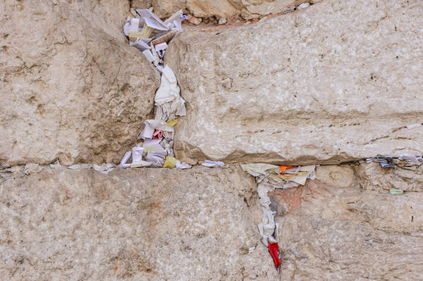istock Tiny prayer notes inserted into the cracks and crevices of the Western Wall holy site in Jerusalem, Israel. 2175593555