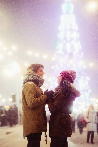 istock Loving Spouses Holding Hands Standing Against Decorated Pine-Tree In City 2175595426