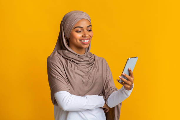 istock Black muslim girl in headscarf using smartphone, texting or browsing internet 2175596531