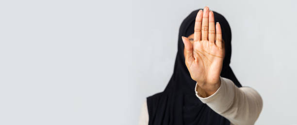 istock Unrecognizable muslim woman in hijab making stop gesture with hand 2175596637