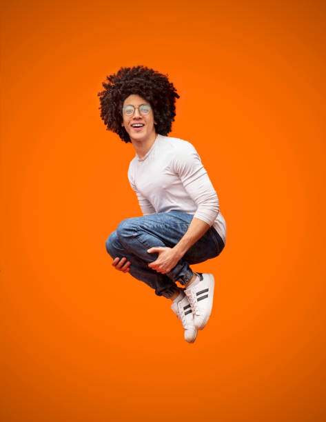 istock Cheerful millennial man jumping in bomb style 2175597234