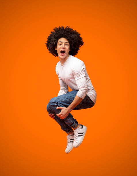 istock Emotional black guy jumping in bomb style and shouting 2175597237