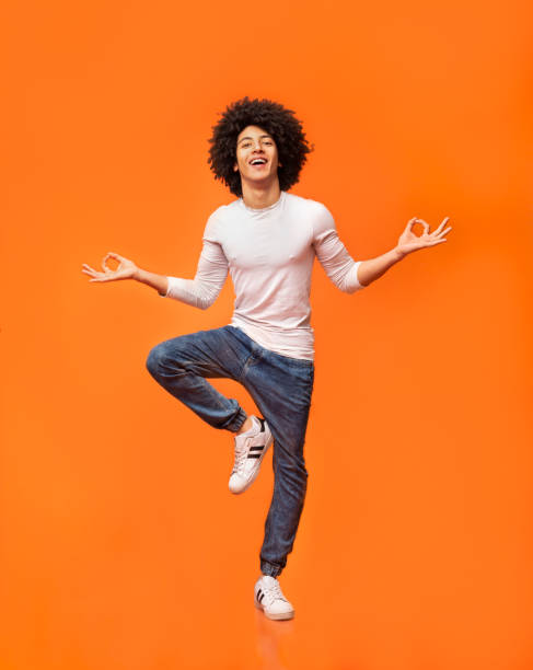istock Funny young man sitting in mid air, balancing on one leg 2175597250