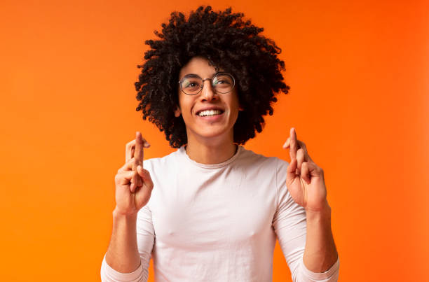 istock Positive african-american guy crossing fingers, making wish 2175597877