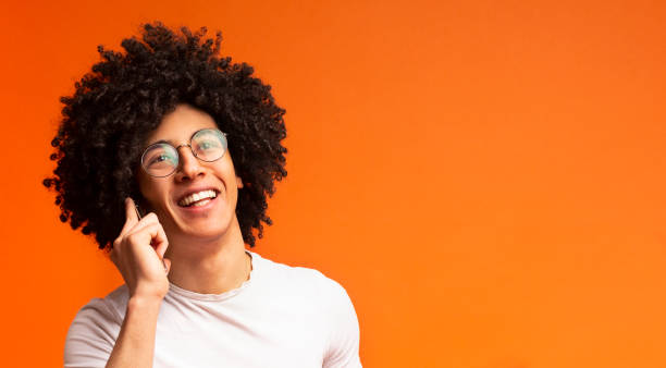 istock Cheerful young black man talking on smartphone 2175597885