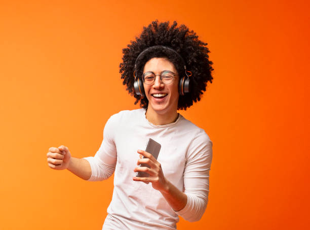 istock Happy man singing into smartphone like microphone 2175597900