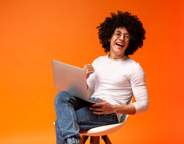 istock Young man working on laptop online at home 2175597908
