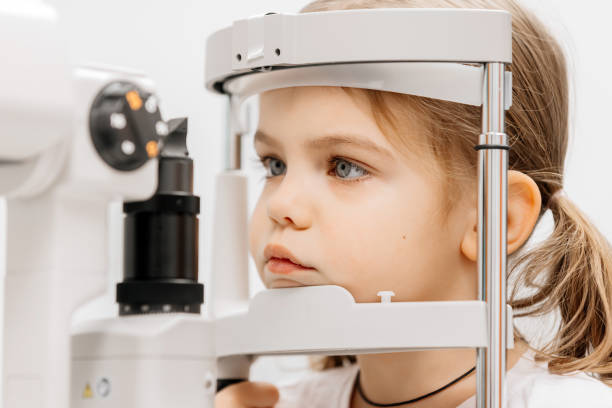 istock Close-up of a little girl with deep eyes undergoing vision diagnostics using a slit lamp in an ophthalmology clinic. A perfect moment highlighting the importance of caring for children's vision. 2175598681